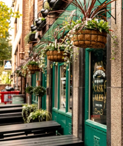 The exterior of the venue with outdoor seating benches at The Lucas Arms.