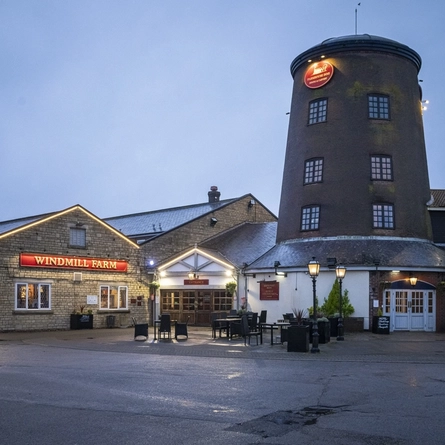 Exterior facade of a pub with a seating area.