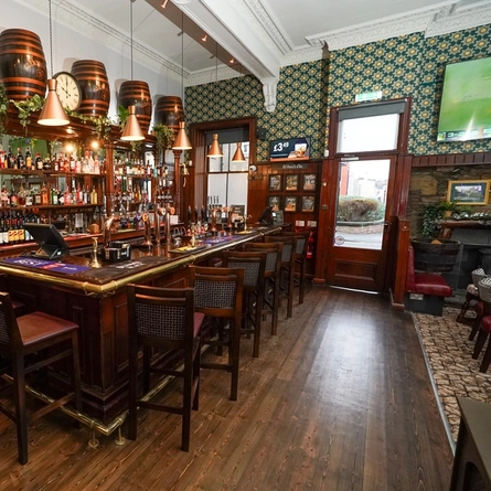 The interior bar with bar stool seating at The Auld Hoose.