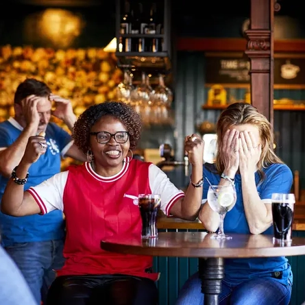 Football fans watching football in the pub