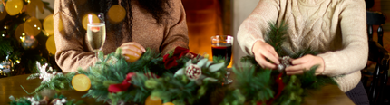 An image of 2 people enjoying drinks during a wreath making workshop at a Chef & Brewer venue.