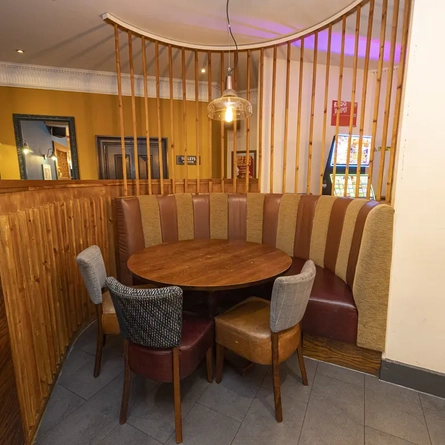 Interior dining area of a pub with a gambling machine.