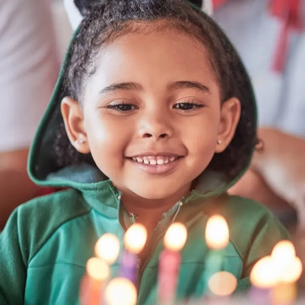 A child and a birthday cake