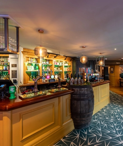 Interior dining area of a pub with a bar.