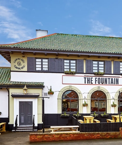 The exterior facade with outdoor seating area at The Fountain.