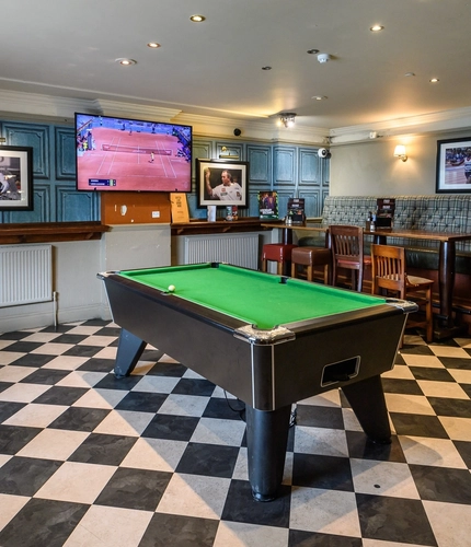 Interior shot of the pool table and the restaurant seating area