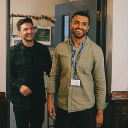Two customers walking into the seating area at a Greene King venue.