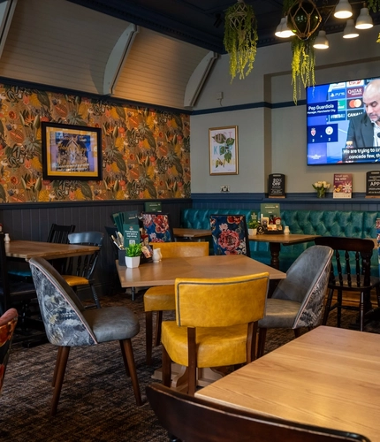 The interior restaurant and seating area with TV at the Ship and Royal.