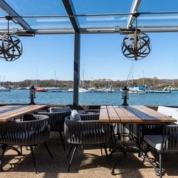 Outdoor dining by the water at The Folly