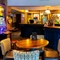 Interior dining area of a pub with a bar and a gambling machine.