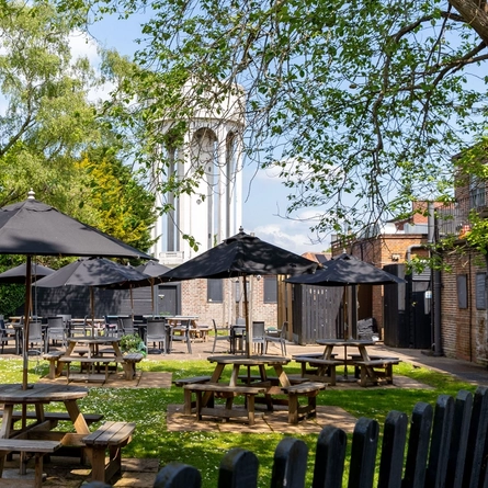 Exterior beer garden of a pub with a seating area.