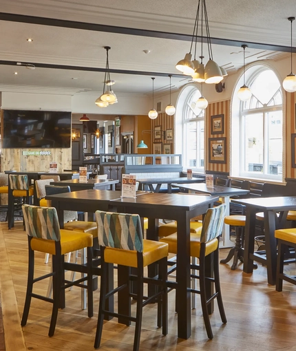 The interior restaurant and seating area with TV at The Fountain.