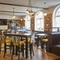 The interior restaurant and seating area with TV at The Fountain.