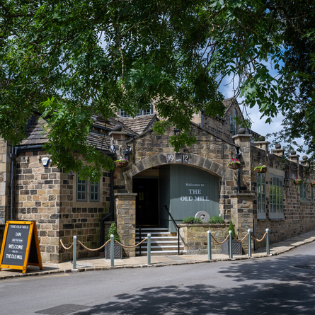 The exterior facade and signage of The Old Mill in Brighouse.