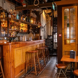 The interior bar with bar stools and seating area at the Ubiquitous Chip.