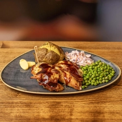 A plateed Chicken New Yorker meal on a wooden table.