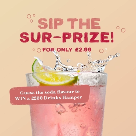 A banner showing a piece of lime falling into a pink coloured drink to advertise a Mystery Soda competition with a chance to win a drinks hamper at Farmhouse Inns venues.