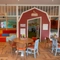 The interior restaurant seating area with tables, chairs and children's Farmyard themed play area at The Farmhouse Kitchen Willington.