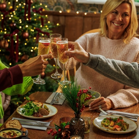An image of people enjoying various festive starters and drinks within the interior restaurant seating area during Christmas time at The Watermill.