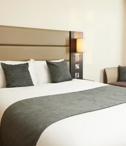 The interior of one of the hotels room featuring a double bed and sofa bed at The Quays.