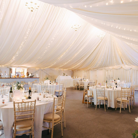 A marquee, decorated for a wedding.