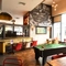 Interior dining area of a pub with a TV and a pool table.