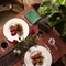 A view of one of the tables within the interior restaurant and seating area viewed from above with hanging plants at The Ubiquitous Chip.