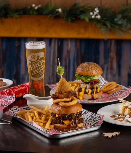 plates of food sitting on a wooden table of a pub