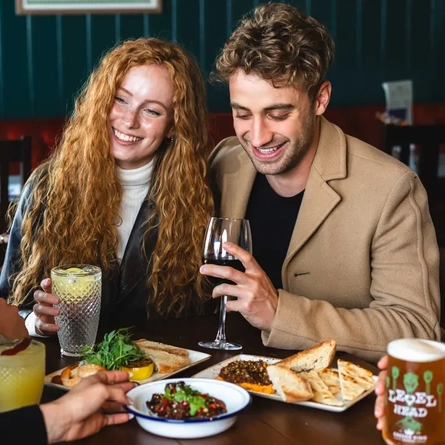 People sitting together around their food and drinks