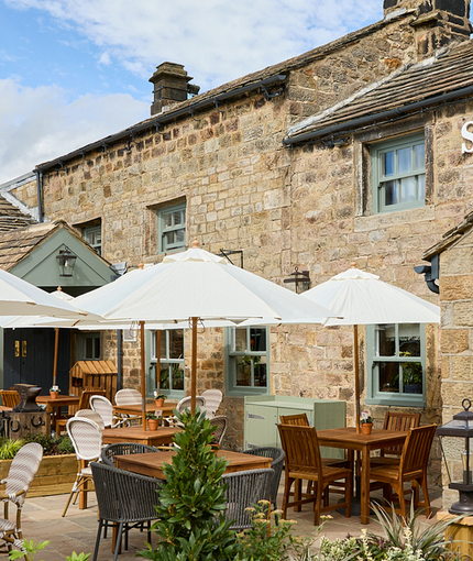 The exterior facade, signage, and beer garden seating area of the Smiths Arms pub in Beckwithshaw.