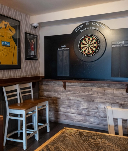interior dining area of a pub with a dartboard