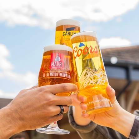 An exterior shot of people enjoying alcoholic drinks served in a beer garden at the Mill House in Stretton.