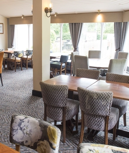 Interior dining area of a pub with a TV.