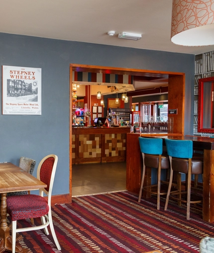 Interior dining area of a pub with a bar.