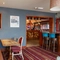 Interior dining area of a pub with a bar.