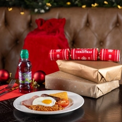 A kids breakfast on a table, next to some presents.