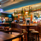 The interior restaurant seating area and wood panelled bar inside The Junction, with gaming machines.