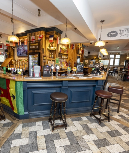 Interior dining area and bar area of a pub.