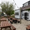 Exterior beer garden of a pub with a seating area.