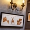 Picture of cows and a deer on a wall