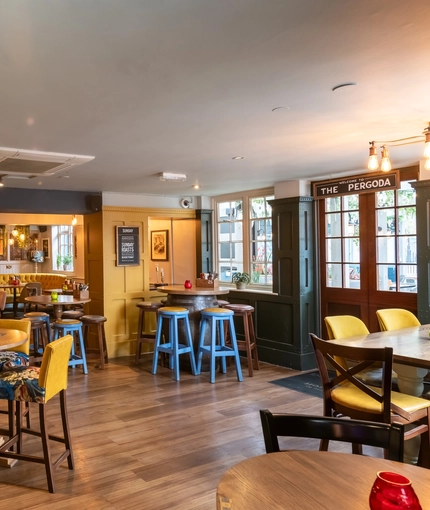 Interior dining area of a pub with a TV.