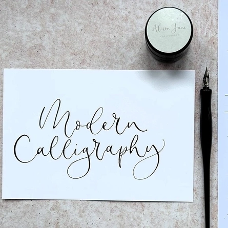 An image of calligraphy writing and pen advertising a Calligraphy Workshop What's On event at The Cart & Horses.