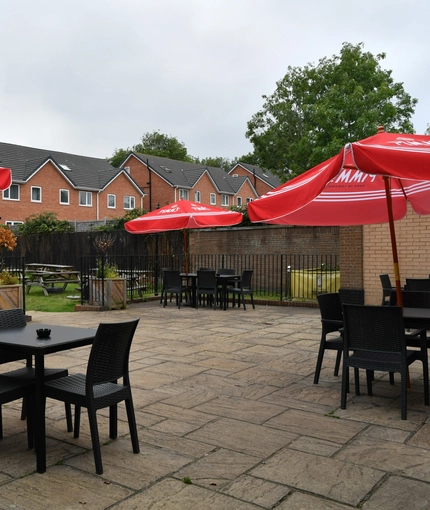 exterior beer garden of a pub with a seating area and a play area