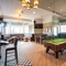 The interior pub games area with pool table, seating and TV at the Black Horse.