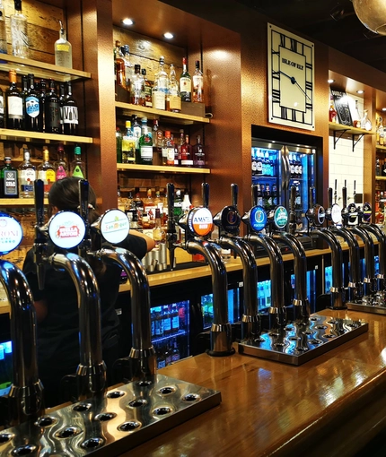 Bar with lots of bottles placed neatly in a row