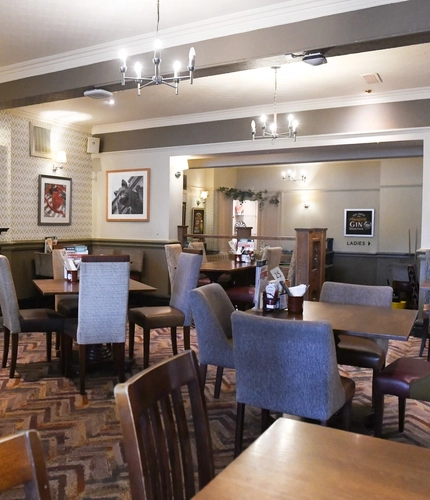interior dining area of a pub with a fireplace