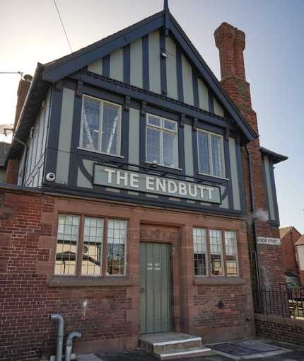 Exterior of the pub with the name above the entrance.