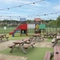 Exterior play area and beer garden of a pub with a seating area.