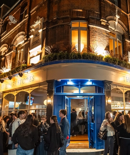 An image of crowds of people stood outside the venue during the evening The Kings Stores.