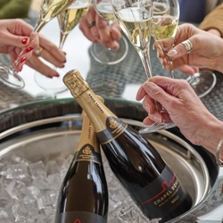 An image of people holding glasses of Chapel Down celebrating with a cheers to advertise a Chapel Down Sampling What's On event at Crafted venues.